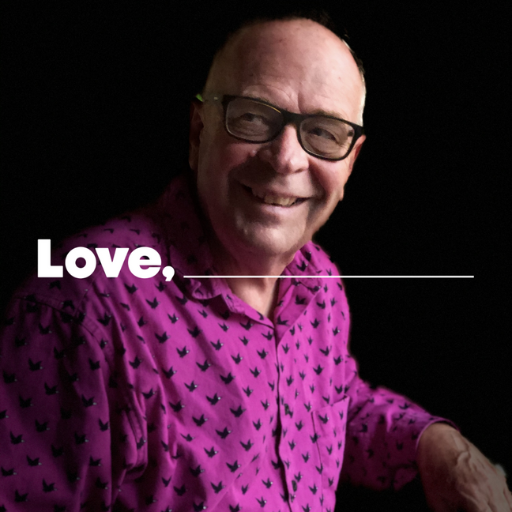 Man with glasses in a purple shirt smiling